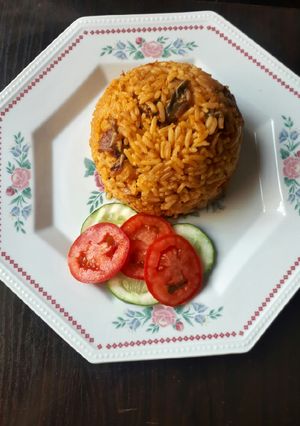 A picture of Jollof rice with dried fish.
