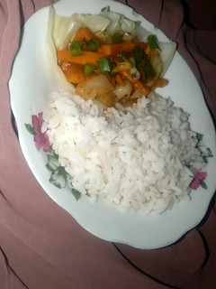 A picture of White rice with vegetable soup.