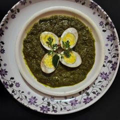 A picture of Green gravy with Afghani egg curry.