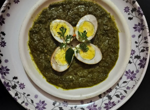 A picture of Green gravy with Afghani egg curry.