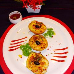 A picture of Baked cheesy potato boat with loaded paneer and mushroom.