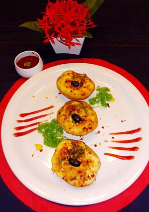 A picture of Baked cheesy potato boat with loaded paneer and mushroom.