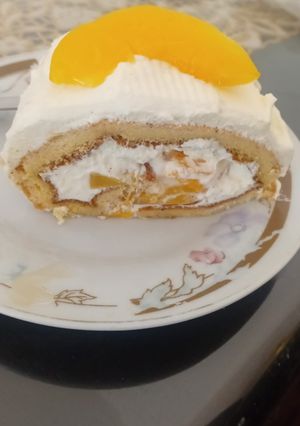 Una foto de Pionono con Crema Chantilly y Duraznos