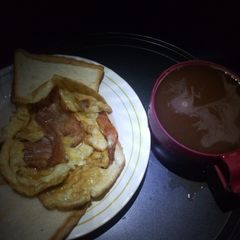 Fried bacon and egg with hot drinking chocolate A picture of Fried bacon and egg with hot drinking chocolate.