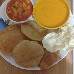 A picture of Aloo Puri Aam Ras.