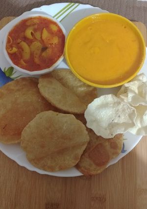 A picture of Aloo Puri Aam Ras.