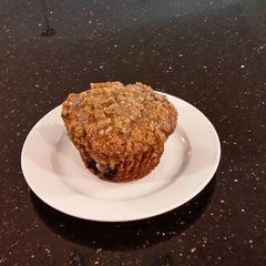 A picture of Blueberry Strusel Muffins with a White Chocolaye Drizzle.