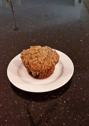 A picture of Blueberry Strusel Muffins with a White Chocolaye Drizzle.
