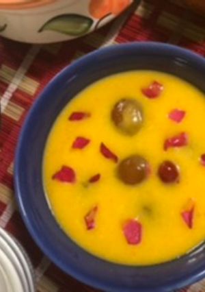 A picture of Mango custard with gulab jamun.