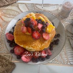 Pancakes with loads of fruits and honey A picture of Pancakes with loads of fruits and honey.