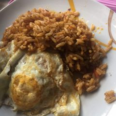 A picture of Quickie Jollof Rice and Sunny Side Up.