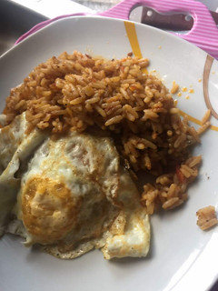 A picture of Quickie Jollof Rice and Sunny Side Up.