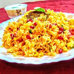 A picture of Tomato and corn biryani.
