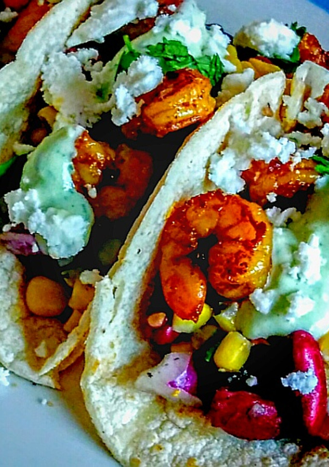 A picture of Blackened Cajun Shrimp Tacos with Cilantro Lime dressing.