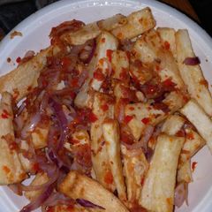A picture of Fried yam with Red pepper and onion sauce.
