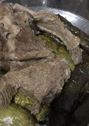 A picture of Stuffed Grape Leaves with Lamb Chops.