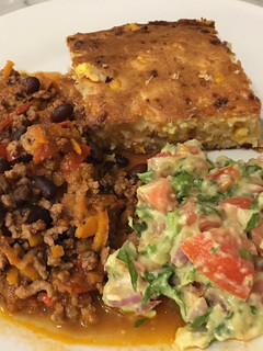 A picture of Chilli con Carne with corn bread.