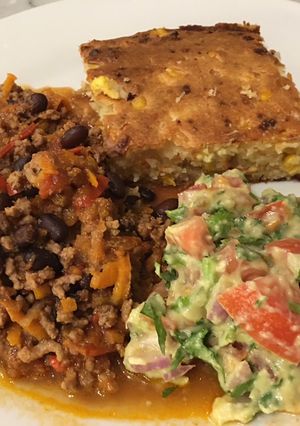 A picture of Chilli con Carne with corn bread.