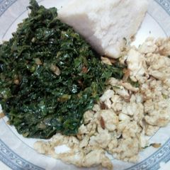 Tasty sukumawiki served with eggs A picture of Tasty sukumawiki served with eggs.