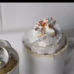 A picture of Vanilla mug cake with whipped cream and sprinkles.