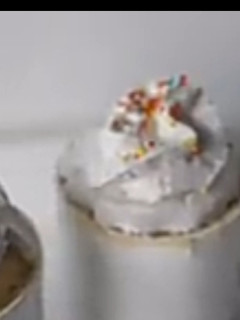 A picture of Vanilla mug cake with whipped cream and sprinkles.