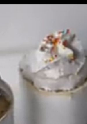 A picture of Vanilla mug cake with whipped cream and sprinkles.