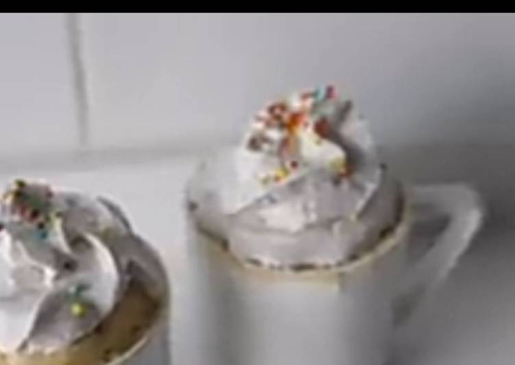 Vanilla mug cake with whipped cream and sprinkles