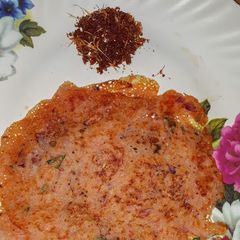 A picture of Tomato dosa with garlic powder.