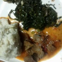 A picture of Beef stew Served with Fried Kale.