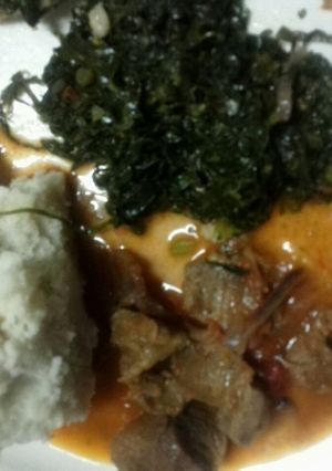 A picture of Beef stew Served with Fried Kale.