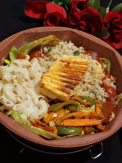 A picture of Veg Sizzler with Paneer Steak and white sauce Pasta.