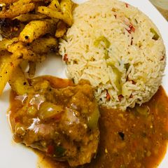 A picture of Spicy chicken machurian with fried rice and masala fries.