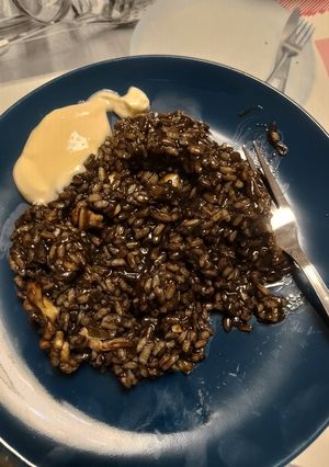 Una foto de Arroz negro con pescado y alioli