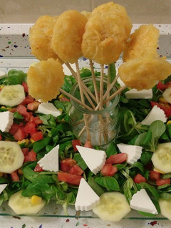 Una foto de Ensalada de canónigos y piruletas de queso