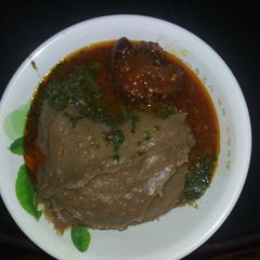 A picture of Amala(yam flour) with Ewedu and cow tail stew.