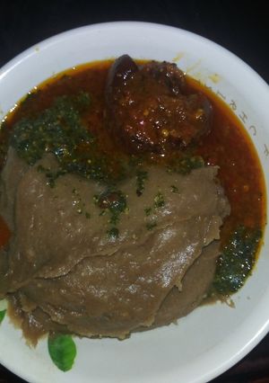 A picture of Amala(yam flour) with Ewedu and cow tail stew.