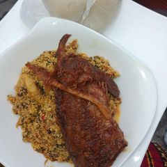 A picture of Egusi soup with bitter leaves and fish.