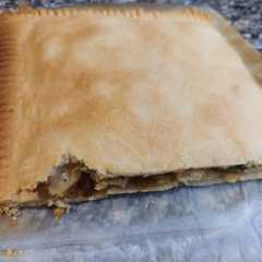 Una foto de Empanada de pollo, brie, cebolla caramelizada y calabacín