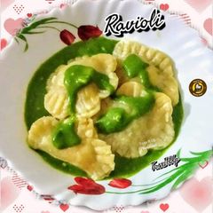 A picture of Veg Ravioli In Spinach Cream Sauce.