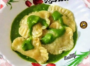 A picture of Veg Ravioli In Spinach Cream Sauce.
