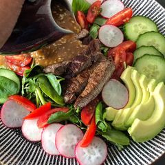 A picture of Steak salad with shoyu dressing.