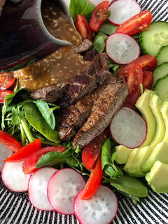 A picture of Steak salad with shoyu dressing.