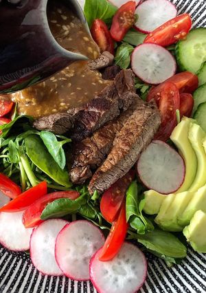 A picture of Steak salad with shoyu dressing.