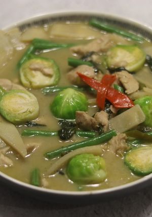 A picture of Thai green curry with brussel sprouts.