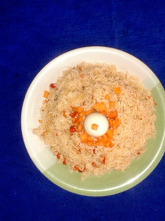 A picture of Jollof rice with boiled rice egg.