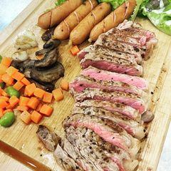 A picture of Strip loin steak with simple side dish.