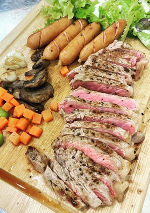 A picture of Strip loin steak with simple side dish.