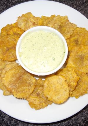 A picture of Tostones (Patacones) with Green Garlic Sauce.