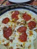 Pizza con cherry asados