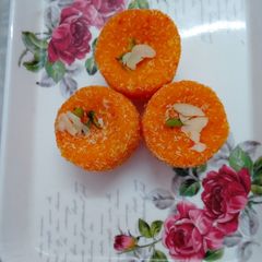 Orange coconut ladoo A picture of Orange coconut ladoo.